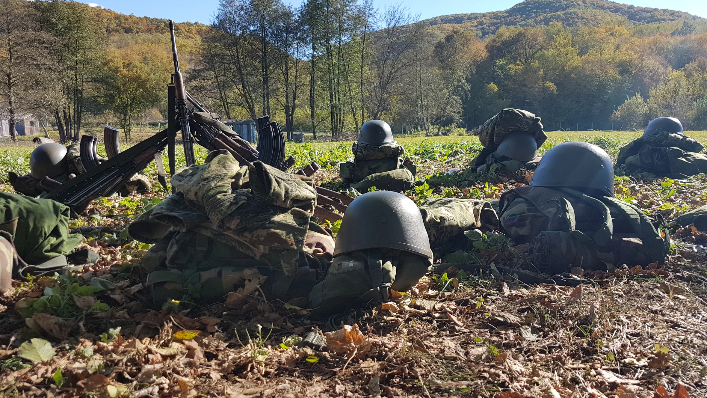 Soldiers in prone position with rifles during autumn field training